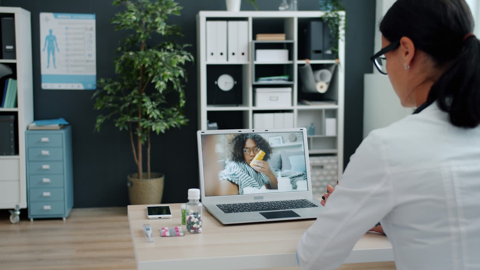A doctor consulting with a patient over a virtual telehealth call